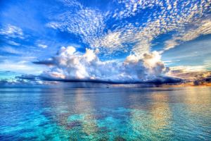 Bright blue water and light cloudy sky at one of the Maldives islands.